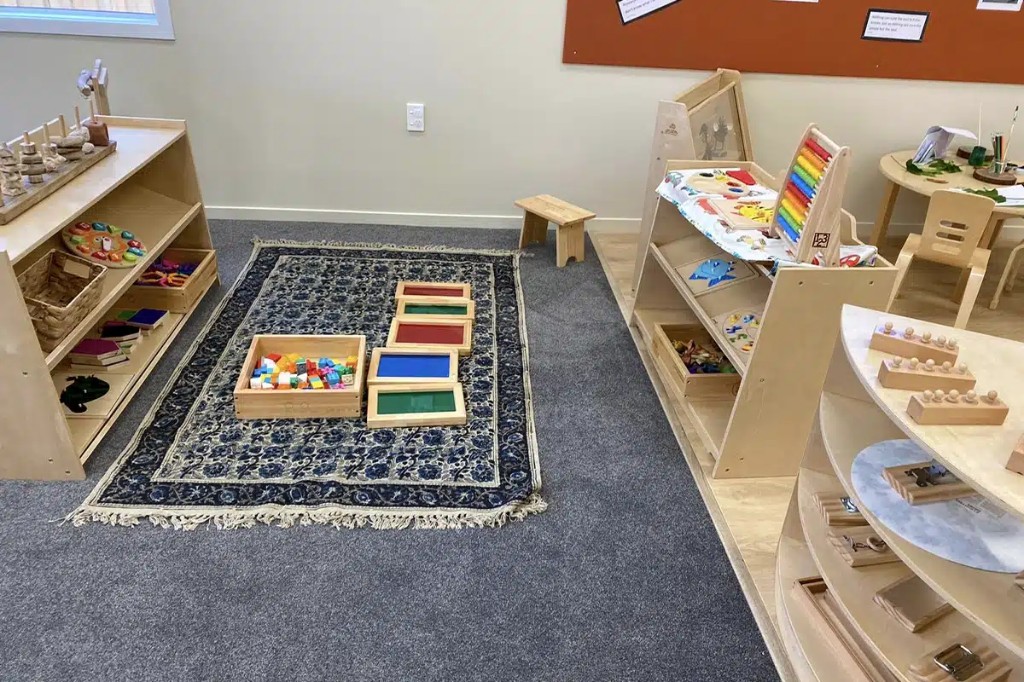 Open-ended materials on a patterned rug with translucent colour panels and loose parts